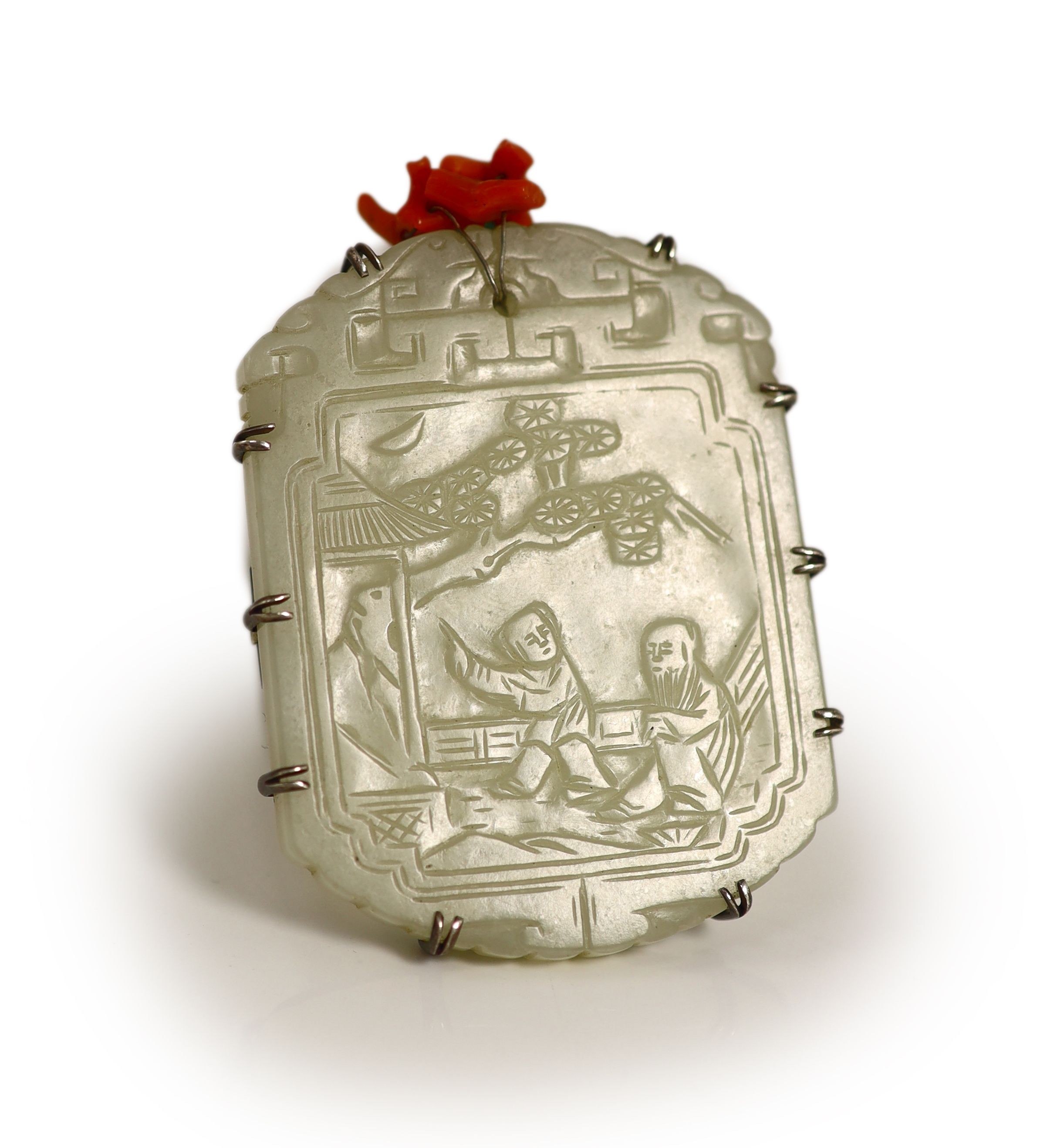 A Chinese pale celadon jade plaque, 19th century, 5.5 cm high, later white metal brooch mount